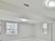 Finished basement with two windows and recessed lighting at 2836 Crescendo Dr, Atlanta, GA 30318