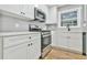 Modern kitchen with white cabinets and stainless steel appliances at 2836 Crescendo Dr, Atlanta, GA 30318