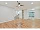 Spacious living area with hardwood floors, a ceiling fan, and access to upper level at 2836 Crescendo Dr, Atlanta, GA 30318