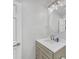 Bathroom featuring a vanity with storage, modern fixtures and a round mirror at 218 Forkner Dr # D, Decatur, GA 30030