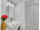 Bathroom featuring a sink, mirror, vanity lights, and a closet at 218 Forkner Dr # D, Decatur, GA 30030