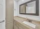 Bathroom featuring granite countertop, vanity with storage, and framed mirror at 218 Forkner Dr # D, Decatur, GA 30030