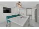 Modern kitchen island with a sink and seating, complemented by modern light fixture and stainless steel refrigerator at 218 Forkner Dr # D, Decatur, GA 30030