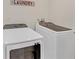 Functional laundry room featuring modern washer and dryer units with 'Laundry' sign at 218 Forkner Dr # D, Decatur, GA 30030