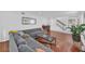 Spacious living room featuring a large gray sectional, hardwood floors, and staircase at 218 Forkner Dr # D, Decatur, GA 30030