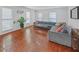 Bright living room with hardwood floors, large gray sofa, and plenty of natural light at 218 Forkner Dr # D, Decatur, GA 30030