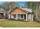 Renovated craftsman bungalow with a white brick exterior, wood accents, and a lush lawn at 458 Holly Nw St, Atlanta, GA 30318