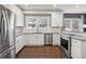 White shaker cabinets, granite counters, stainless steel appliances in this kitchen at 458 Holly Nw St, Atlanta, GA 30318