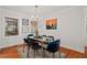 Bright dining room with hardwood floors, glass-top table, and blue chairs at 478 Pensdale Rd, Decatur, GA 30030