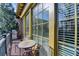 Sunny outdoor balcony with a table, chairs, grill, and views of the surrounding community at 5890 Bond St, Cumming, GA 30040