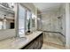 Bathroom featuring double vanity with granite counters and tiled glass enclosed shower and private commode at 5890 Bond St, Cumming, GA 30040
