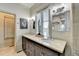 Bathroom featuring double vanity with granite counters, framed mirror, and decorative light fixture at 5890 Bond St, Cumming, GA 30040