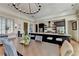 Open-concept dining room and kitchen with a large island, granite countertops, and seating for eight people at 5890 Bond St, Cumming, GA 30040