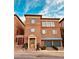 Charming brick townhome with blue shutters and a two-car garage, showcasing classic architectural details at 5890 Bond St, Cumming, GA 30040