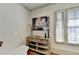 Hallway featuring a console table with artwork and window with blinds at 5890 Bond St, Cumming, GA 30040