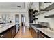 This kitchen features wood floors, granite countertops and stainless steel appliances at 5890 Bond St, Cumming, GA 30040