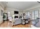 Bright and airy living room with hardwood floors, fireplace, and large windows at 5890 Bond St, Cumming, GA 30040