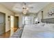 Spacious main bedroom with hardwood floors, detailed trim and ceiling fan with adjoining en-suite bathroom at 5890 Bond St, Cumming, GA 30040