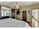 This main bedroom has hardwood floors, a ceiling fan, and an ensuite bathroom at 5890 Bond St, Cumming, GA 30040
