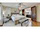 Spacious main bedroom suite features hardwood floors, a ceiling fan, and access to ensuite bathroom at 5890 Bond St, Cumming, GA 30040