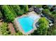 Aerial view of a community pool surrounded by trees and lounge chairs at 5890 Bond St, Cumming, GA 30040