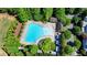 Aerial view of a community pool surrounded by trees and lounge chairs at 5890 Bond St, Cumming, GA 30040