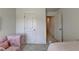 Bedroom with pink armchair and hallway view at 1591 Salem Dr # 76, Conyers, GA 30013