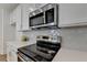 Stainless steel appliances and white cabinets in this kitchen at 1591 Salem Dr # 76, Conyers, GA 30013