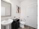 Simple bathroom with pedestal sink and dark vanity at 4130 Grandview Vista St, Cumming, GA 30028