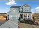 Two-story house with gray siding, three-car garage, and front porch at 4130 Grandview Vista St, Cumming, GA 30028