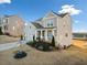 Gray two-story house with a three-car garage and landscaped yard at 4130 Grandview Vista St, Cumming, GA 30028