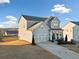 Two-story house with gray siding, three-car garage, and driveway at 4130 Grandview Vista St, Cumming, GA 30028