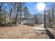 Large backyard with wooded area and a patio at 5224 Martins Crossing Rd, Stone Mountain, GA 30088