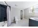 Basement bathroom with dark-tiled shower and white flooring at 9585 Hutcheson Ferry Rd, Palmetto, GA 30268