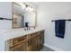 Modern bathroom with wood vanity, quartz countertop, and stylish fixtures at 9585 Hutcheson Ferry Rd, Palmetto, GA 30268