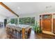 Bright dining room with hardwood floors, large windows, and a modern wood table at 9585 Hutcheson Ferry Rd, Palmetto, GA 30268