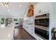 Updated kitchen with white cabinets, stainless steel appliances, and a wood range hood at 9585 Hutcheson Ferry Rd, Palmetto, GA 30268