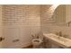 Small powder room with white subway tile and wood flooring at 120 Ridgely Ct, Atlanta, GA 30342