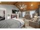Large bedroom with a cozy sitting area and fireplace at 3228 Rosebud Rd, Loganville, GA 30052