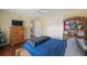 Bright bedroom with wooden platform bed and hardwood floors at 3228 Rosebud Rd, Loganville, GA 30052