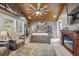 Bright bedroom with a rustic wooden bed frame and fireplace at 3228 Rosebud Rd, Loganville, GA 30052