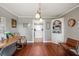 Spacious dining room with hardwood floors and views to kitchen and living areas at 3228 Rosebud Rd, Loganville, GA 30052