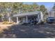 Gray metal building with covered porch, perfect for workshop or storage at 3228 Rosebud Rd, Loganville, GA 30052