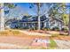 Gray ranch home with a two-car garage and mature trees at 3228 Rosebud Rd, Loganville, GA 30052