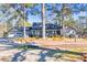 Gray ranch home with a two-car garage, front porch and mature trees at 3228 Rosebud Rd, Loganville, GA 30052