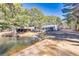 Home with detached shop and pond in the background at 3228 Rosebud Rd, Loganville, GA 30052