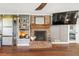 Brick fireplace with wood mantel in a living room at 3228 Rosebud Rd, Loganville, GA 30052