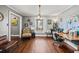 Home office with wood floors, built-in shelving, and a large desk at 3228 Rosebud Rd, Loganville, GA 30052