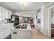 Spacious kitchen with white cabinets, island, and stainless steel dishwasher at 3228 Rosebud Rd, Loganville, GA 30052