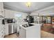Modern kitchen with white cabinets, stainless steel appliances, and an island at 3228 Rosebud Rd, Loganville, GA 30052